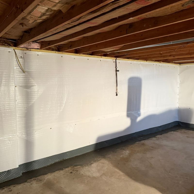 The same basement walls covered in white waterproofing