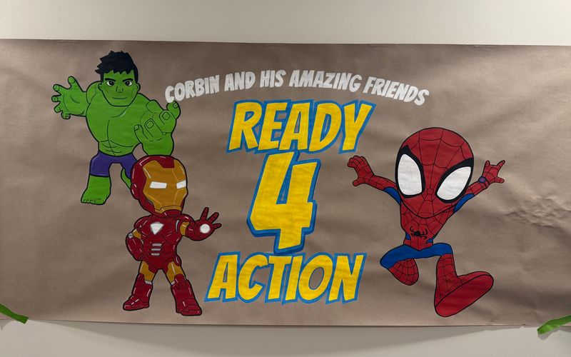 Handmade superhero birthday poster on kraft paper with Hulk, Iron Man and Spider-Man, for Corbin and his friends