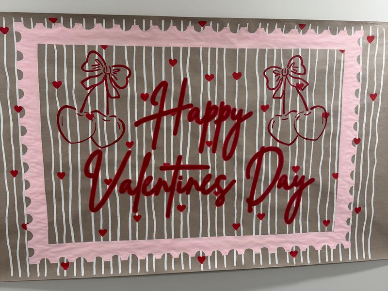 Handmade poster on kraft paper with pink borders, cherries and hearts, reading happy Valentine&rsquo;s Day