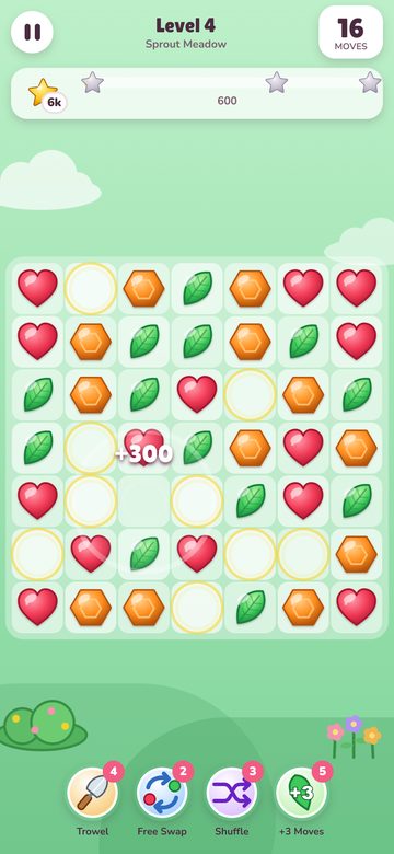 The Sugarbloom game on a phone, a green match three board of hearts, leaves and orange gems